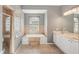Bathroom features a large soaking tub, double vanity, and glass block window at 3623 Monday Ter, North Port, FL 34286