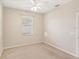 Simple bedroom with ceiling fan and neutral wall color at 3623 Monday Ter, North Port, FL 34286