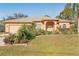 Tan house with gray roof, two-car garage, and landscaped yard at 3623 Monday Ter, North Port, FL 34286