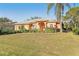 Tan house with gray roof, two-car garage, and green lawn at 3623 Monday Ter, North Port, FL 34286
