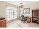 Home office with wood desk, chair, bookcase, and natural light at 3623 Monday Ter, North Port, FL 34286