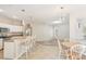 Modern kitchen with white cabinets, stainless steel appliances, and breakfast bar at 3623 Monday Ter, North Port, FL 34286