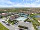 Aerial view of community with pool, tennis, and pickleball courts at 412 Daylily Blvd, Nokomis, FL 34275