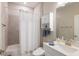 Bathroom with shower/tub combo, vanity, and white cabinet at 412 Daylily Blvd, Nokomis, FL 34275