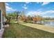 Landscaped backyard with a lake view and lush greenery at 4209 Cascade Falls Dr, Sarasota, FL 34243