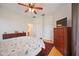 Spacious bedroom with wood floors, ceiling fan, and ample closet space at 4209 Cascade Falls Dr, Sarasota, FL 34243
