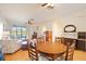 Round wooden dining table with four chairs overlooking the living room at 4209 Cascade Falls Dr, Sarasota, FL 34243