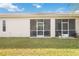 Back exterior view showing a screened lanai and well-maintained lawn at 4209 Cascade Falls Dr, Sarasota, FL 34243