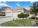 Two-car garage and well-manicured landscaping at 4209 Cascade Falls Dr, Sarasota, FL 34243