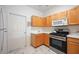 Well-equipped kitchen featuring light wood cabinets and modern appliances at 4209 Cascade Falls Dr, Sarasota, FL 34243