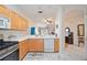 Kitchen with light wood cabinets, stainless steel appliances, and view to living room at 4209 Cascade Falls Dr, Sarasota, FL 34243