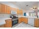 Kitchen with light wood cabinets, stainless steel appliances, and view to living room at 4209 Cascade Falls Dr, Sarasota, FL 34243