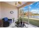 Bright lanai with lake view, wicker furniture, and ceiling fan at 4209 Cascade Falls Dr, Sarasota, FL 34243
