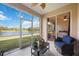 Relaxing screened lanai overlooking a lake, featuring comfortable seating and lush plants at 4209 Cascade Falls Dr, Sarasota, FL 34243
