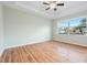 Light and airy bedroom with wood flooring and large window at 5384 Layton Dr, Venice, FL 34293