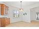 Bright dining area with wood cabinets and tile floors at 5384 Layton Dr, Venice, FL 34293