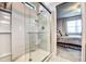 Modern bathroom with a glass shower enclosure, white tile, and built-in shelving at 5616 107Th E Ter, Parrish, FL 34219