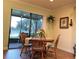 Dining area with natural light, a round wooden table with cushioned chairs, and a view of the outdoors at 5616 107Th E Ter, Parrish, FL 34219