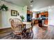 View of the kitchen from the dining area, with updated appliances, a black refrigerator, and wood cabinets at 5616 107Th E Ter, Parrish, FL 34219