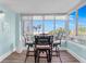 Sunroom with ocean view and seating for four at 5924 Midnight Pass Rd # 209, Sarasota, FL 34242