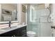 Bathroom with a walk-in shower, modern vanity, and LED mirror at 601 Gulf N Dr # 209, Bradenton Beach, FL 34217