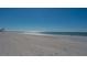 Scenic beach view with white sand and clear water under a bright blue sky at 601 Gulf N Dr # 209, Bradenton Beach, FL 34217