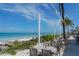 Outdoor dining area on the beach with ocean views at 601 Gulf N Dr # 209, Bradenton Beach, FL 34217