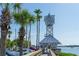 White clock tower with palm trees and walkway at 601 Gulf N Dr # 209, Bradenton Beach, FL 34217