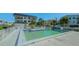 Community pool with surrounding patio furniture at 601 Gulf N Dr # 209, Bradenton Beach, FL 34217