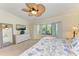 Bright bedroom featuring a TV, dresser, and king-size bed at 6705 Grand Estuary Trl # 206, Bradenton, FL 34212