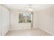 Well-lit bedroom featuring tiled floors and a window at 7145 Bright Creek Dr # 33, Sarasota, FL 34231