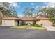 Tan two-unit condo building with attached garages and landscaped yards at 7145 Bright Creek Dr # 33, Sarasota, FL 34231