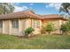 Tan house exterior with a brown roof and landscaping at 7145 Bright Creek Dr # 33, Sarasota, FL 34231