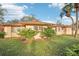 Tan house exterior with a brown roof and landscaping at 7145 Bright Creek Dr # 33, Sarasota, FL 34231