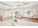 White kitchen with wood countertops and appliances at 7145 Bright Creek Dr # 33, Sarasota, FL 34231