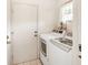 Small laundry room with washer and dryer included at 7145 Bright Creek Dr # 33, Sarasota, FL 34231