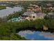 Aerial view of community clubhouse with pool and lush landscaping at 918 River Basin Ct # 101A, Bradenton, FL 34212