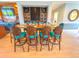 Elegant dining area with a wine wall and teal chairs at 918 River Basin Ct # 101A, Bradenton, FL 34212