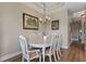 Bright dining area with white table and chairs, and tropical artwork at 918 River Basin Ct # 101A, Bradenton, FL 34212