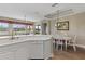 Kitchen features white cabinetry, breakfast bar, and view to dining area at 918 River Basin Ct # 101A, Bradenton, FL 34212