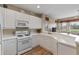 White kitchen with ample counter space and gas cooktop at 918 River Basin Ct # 101A, Bradenton, FL 34212