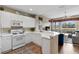 White kitchen with stainless steel appliances and breakfast bar at 918 River Basin Ct # 101A, Bradenton, FL 34212
