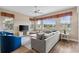 Spacious living room features large windows, sectional sofa, and hardwood floors at 918 River Basin Ct # 101A, Bradenton, FL 34212