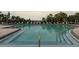 Inviting community pool with lounge chairs and umbrellas at 918 River Basin Ct # 101A, Bradenton, FL 34212