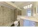 Bathroom with glass shower and updated vanity at 115 Tyler Dr # 203, Sarasota, FL 34236