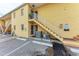 Rear view showing building entrance, stairs, and AC units at 115 Tyler Dr # 203, Sarasota, FL 34236