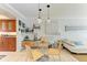 Bright dining area with glass top table, and kitchen partially visible at 115 Tyler Dr # 203, Sarasota, FL 34236