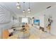 Open concept dining area with glass table and view of living room at 115 Tyler Dr # 203, Sarasota, FL 34236