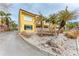Attractive yellow building with palm trees and a paved driveway at 115 Tyler Dr # 203, Sarasota, FL 34236