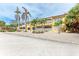 Two story building with palm trees and gravel parking at 115 Tyler Dr # 203, Sarasota, FL 34236